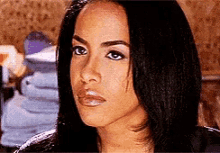 a close up of a woman 's face with a serious look on her face