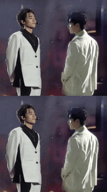 a man in a white suit stands next to a man in a black shirt