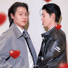 a couple of men standing next to each other with one wearing a balenciaga jacket