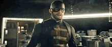 a man in a superhero costume is standing in a warehouse .
