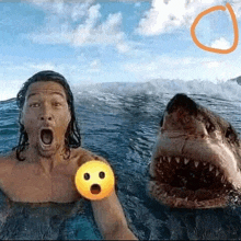 a man is taking a selfie in the ocean with a shark .