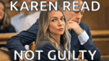 a woman is sitting next to a man in a courtroom with the words karen read not guilty .
