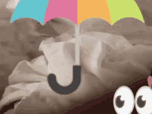 a colorful umbrella is sitting on top of a bed