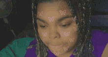 a close up of a person 's face with butterflies on it