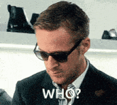 a man wearing sunglasses and a suit has the word who on his face