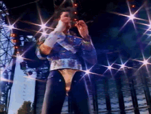 a man standing on a stage with lots of lights