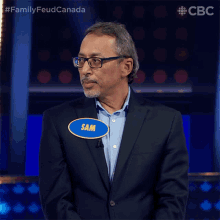 a man with a name tag that says sam on it