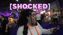 a woman holding a cell phone with the words [ shocked ] written above her