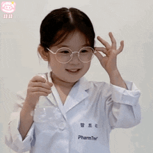 a little girl wearing glasses and a lab coat with the word pharm on the pocket