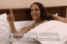 a woman is laying in bed giving the middle finger and screaming .