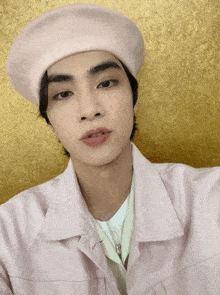 a young man wearing a pink hat and a pink jacket