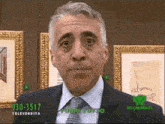 a man in a suit and tie is standing in front of a wall with pictures and a phone number 030-3517