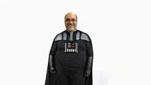 a man in a darth vader costume is smiling for the camera