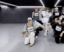 a group of young men are dancing and one has a tag that says ren on it