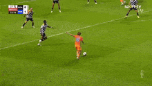 a soccer goalie is diving to save a goal in front of bwin advertisements