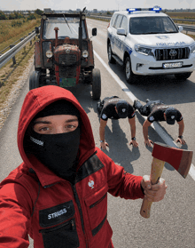 a man in a strauss jacket is holding an axe in front of a police car