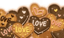 a row of heart shaped cookies that say love