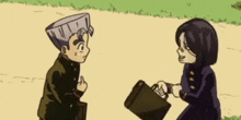 a boy and a girl are standing next to each other in a field . the boy is holding a briefcase .