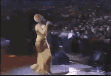 a group of people sitting in a stadium watching a show