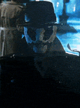a man with a mask on his face is wearing a black hat