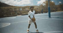 a basketball player wearing a jersey that says emirates fly emirates
