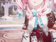 a girl with pink hair and a keychain that looks like a unicorn