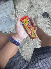 a person is holding a package of butterfinger crackers in their hand