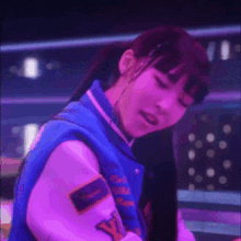 a girl wearing a blue varsity jacket with the letter y on the back
