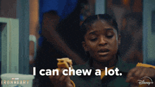 a girl holding a piece of food with the words i can chew a lot