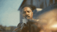 a man with a beard is holding a gun