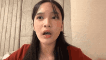 a close up of a woman making a funny face with her tongue out