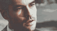 a close up of a man 's face with oblivion written on the bottom right
