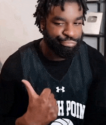 a man with a beard is wearing a jersey that says point
