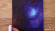 a painting of a galaxy is being made by chloe art