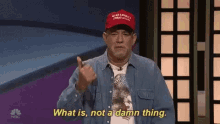 a man wearing a maga hat is giving the middle finger and says what is not a damn thing