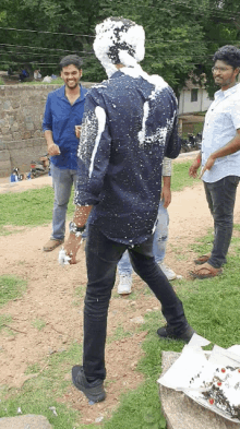 a man in a blue shirt with foam on his head