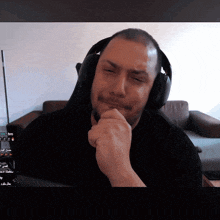 a man wearing headphones is looking at the camera