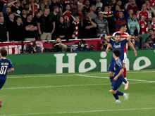 a soccer player with the number 87 on his jersey runs on the field