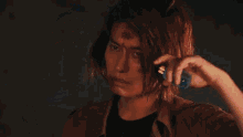 a man is standing in a dark room holding a glowing object in his hand .