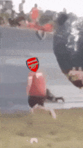 a blurry picture of a person with a soccer ball that says arsenal