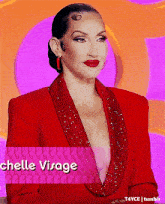 a woman wearing a red jacket with the name michelle visage on the bottom
