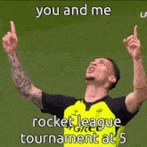 a man in a yellow shirt is pointing up with the words " you and me rocket league tournament at 5 "