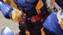 a person in a blue and yellow costume with a belt that says ff on it