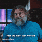 a man with a beard is wearing a blue sweater that says first we mine then we craft