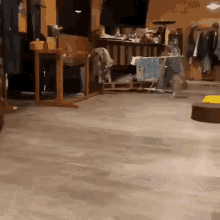 a room with a lot of clothes on the floor and a table