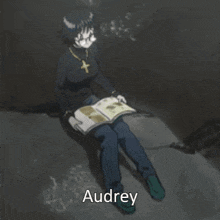 a girl reading a book with the name audrey on the bottom right