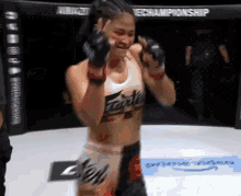 a woman in a boxing ring with the word fairtex on her shirt