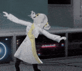 a woman in a white coat is dancing in front of a server room