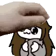 a hand is petting a cartoon character 's head with a towel .