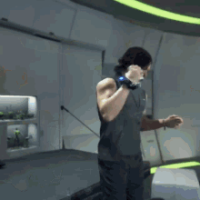 a man with a watch on his wrist is standing in a room